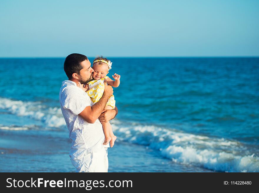 Happy father playing with cute little daughter at the beach. Rest in Turkey.