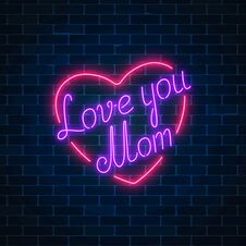 Happy Mothers Day Neon Glowing Festive Sign On A Dark Brick Wall Background. Love You Mom In Heart Shape. Stock Image