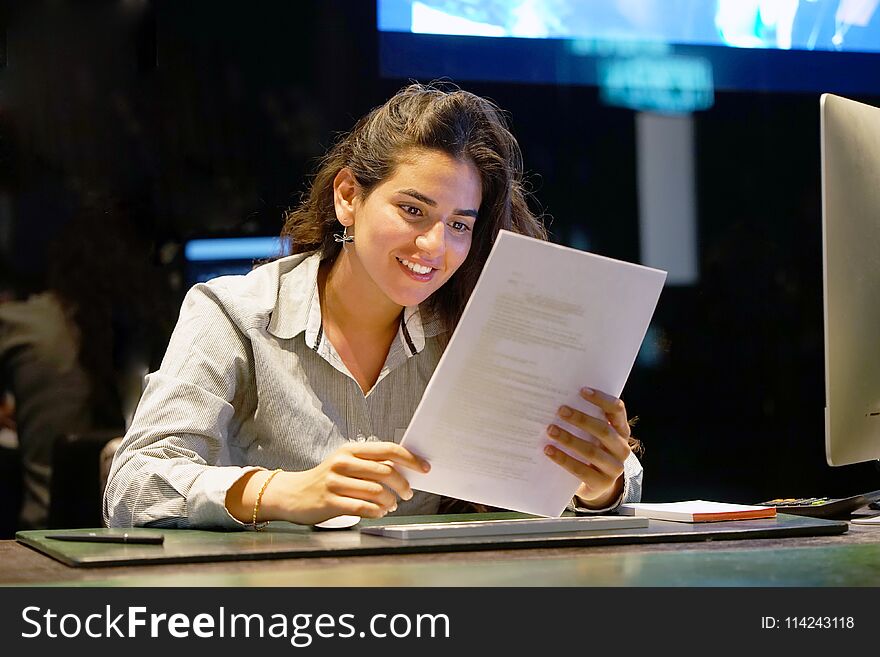 Happy entrepreneur woman reading good news in a letter in the offes. Reception in the hotel.