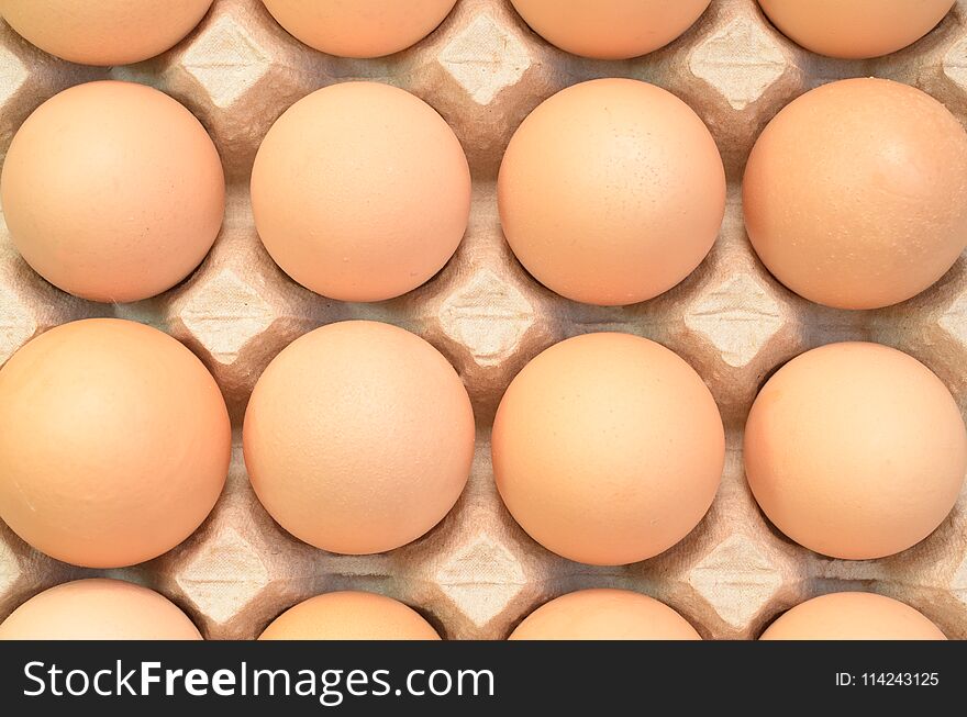Brown eggs in a cardboard tray for eggs.