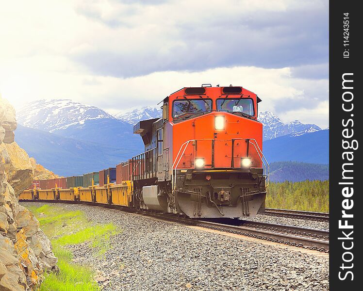 Long freight train moves through Canadian Rockies. Long freight train moves through Canadian Rockies.