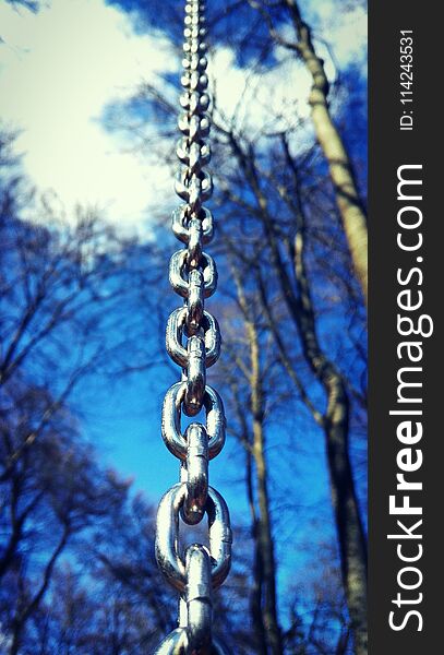 Photo of a chain on a blue sky backround. Photo of a chain on a blue sky backround