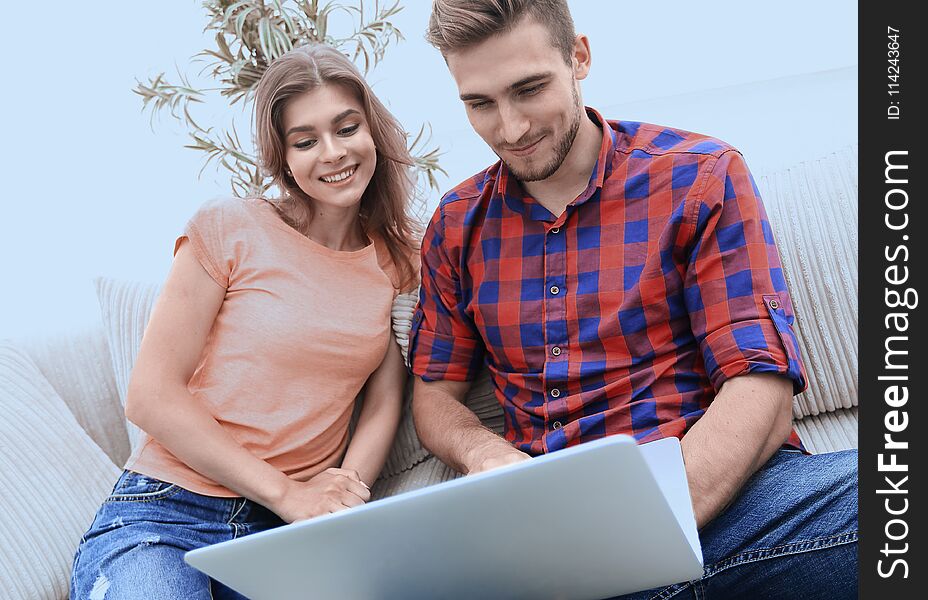 Happy modern couple surfing the net and working on laptop at home.photo with copy space