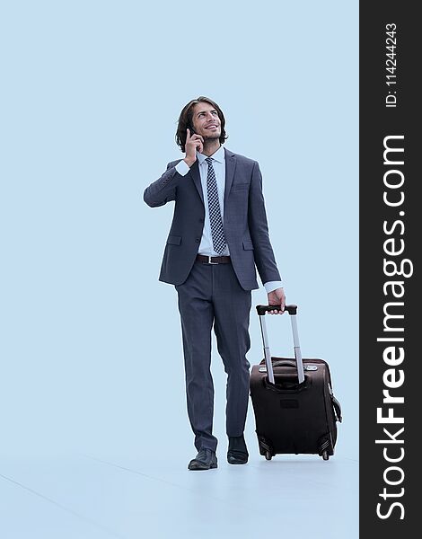 Successful businessman with travel suitcase talking on the phone. photo with copy space