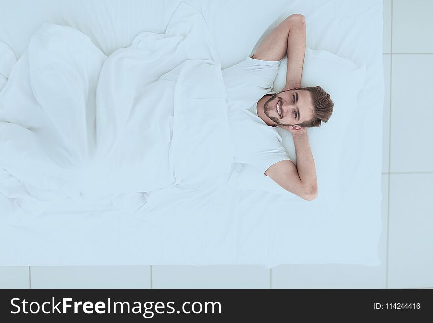 Top view.smiling man relaxing on the couch .photo with copy space