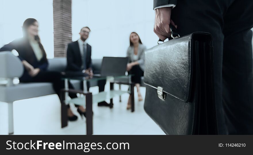 Close-up photo of hand of businessman with briefcase. Close-up photo of hand of businessman with briefcase.