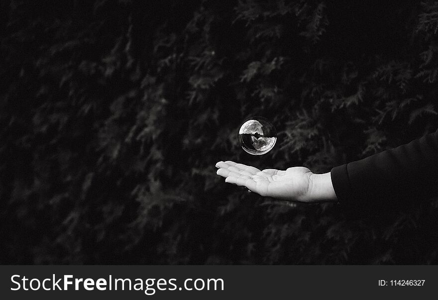 Soap bubble on dark background palm child