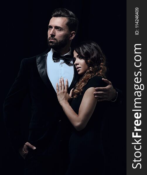 Portrait of fashion couple on black background