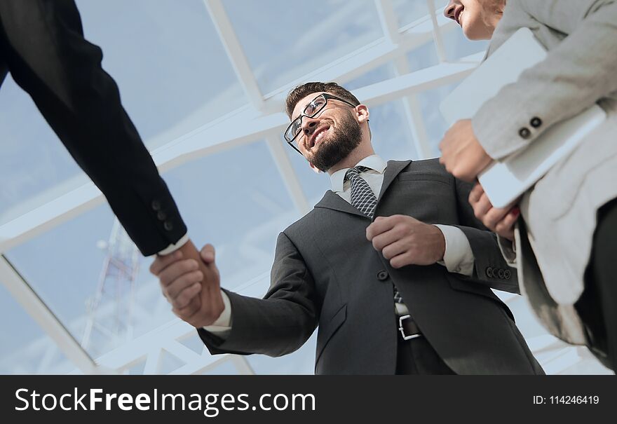 Close-up shot of businessmen shaking hands in the office. Close-up shot of businessmen shaking hands in the office