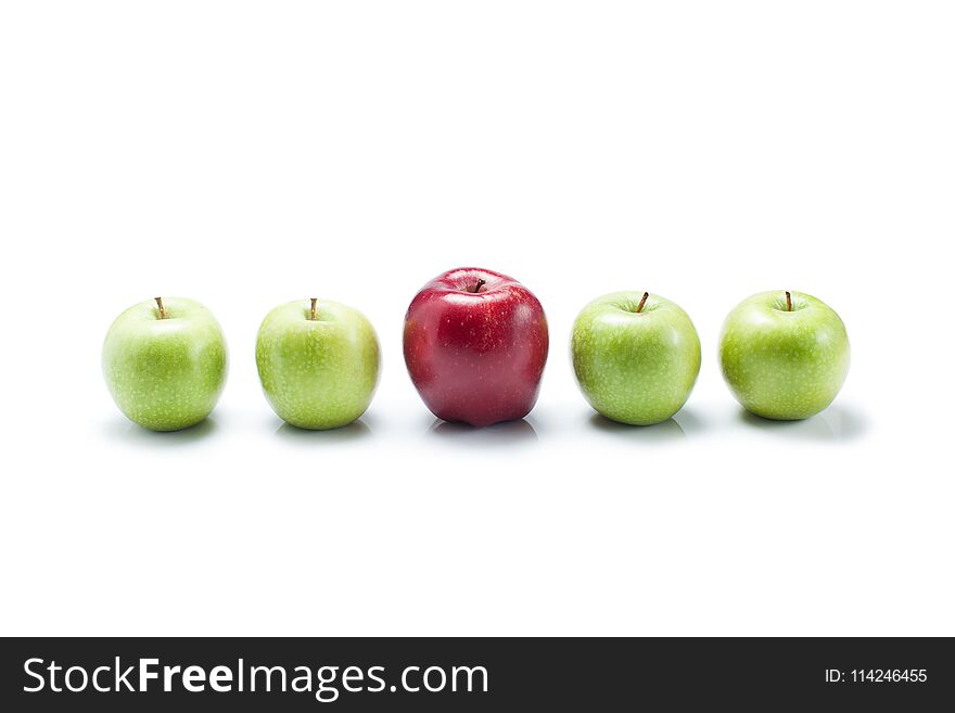 One bite red apple among green apples on white background to be not like others. One bite red apple among green apples on white background to be not like others