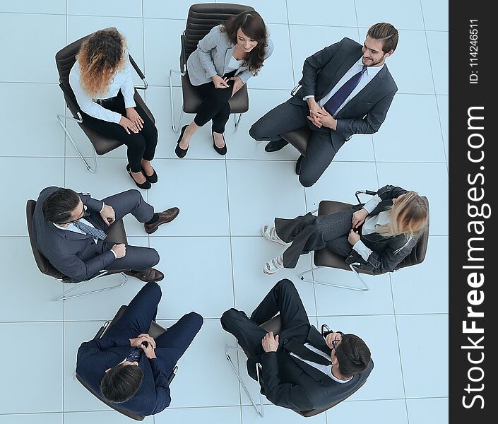 Top View Of Business Team Discussing New Ideas.