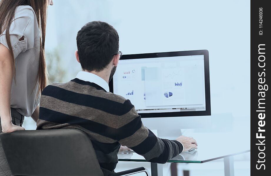 Employees analyzing the marketing graphics on the computer.photo with copy space