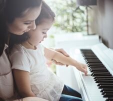 Mom Teaching Her Daughter Piano Playing Stock Image