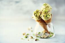 Green Ice Cream In Waffle Cone With Chocolate And Pistachio Nuts On Grey Stone Background. Summer Food Concept, Copy Stock Images
