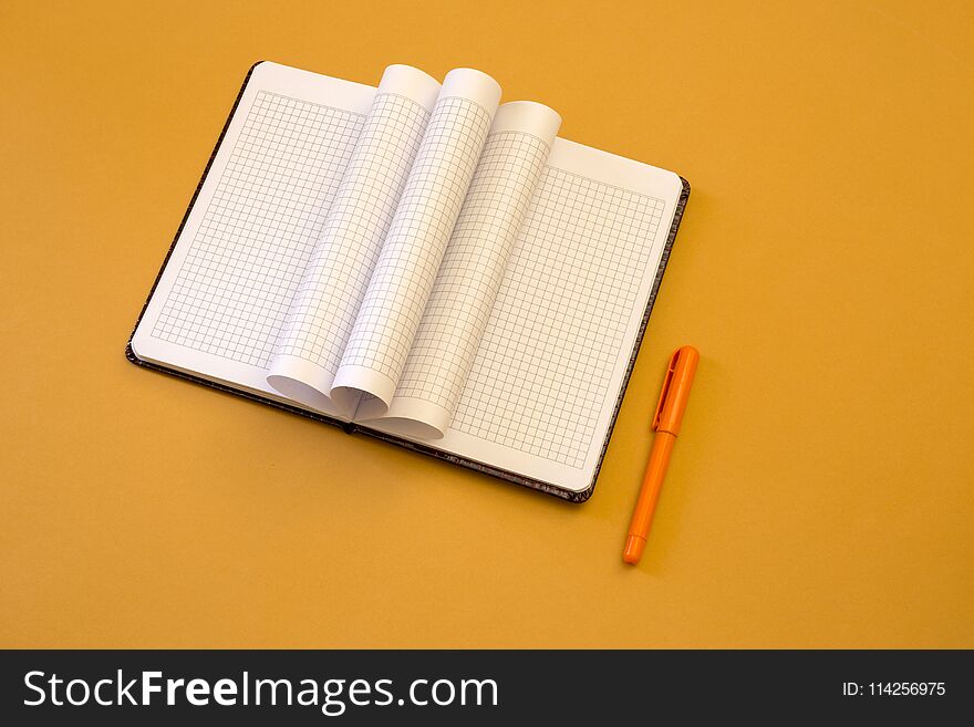 Open Notebook With Pen On Yellow Background