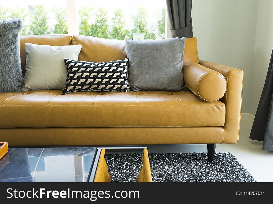 Modern decorative pillow on brown leather sofa in living room. Modern decorative pillow on brown leather sofa in living room