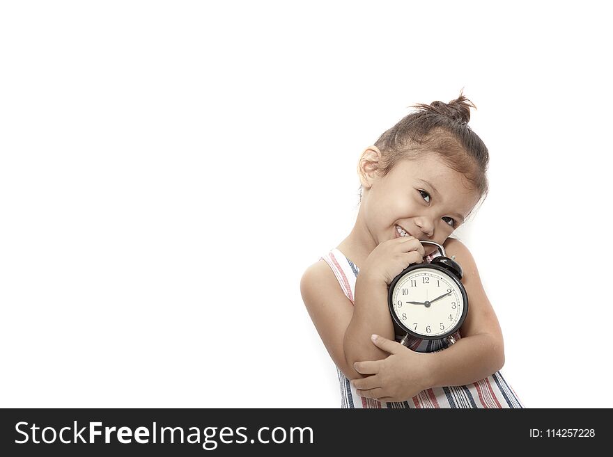 asian baby kid girl playing black alarm clock on gray background. asian baby kid girl playing black alarm clock on gray background