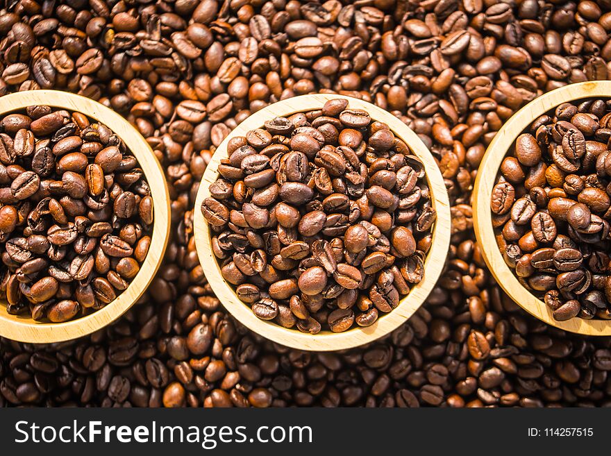 Brown coffee beans in wood bowl