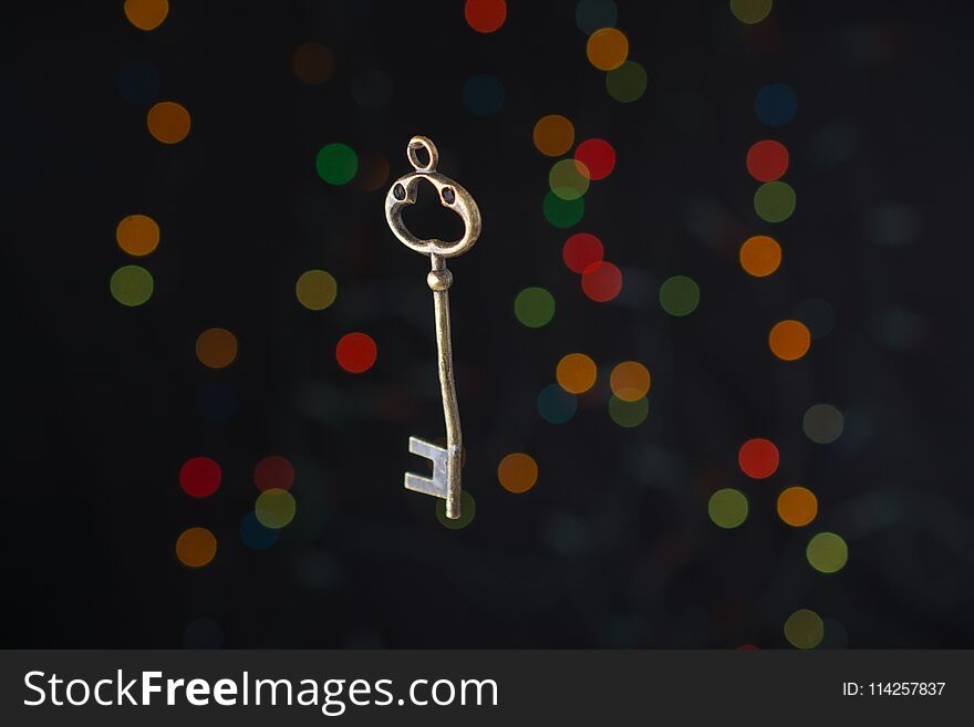 Retro style key on a bokeh light background