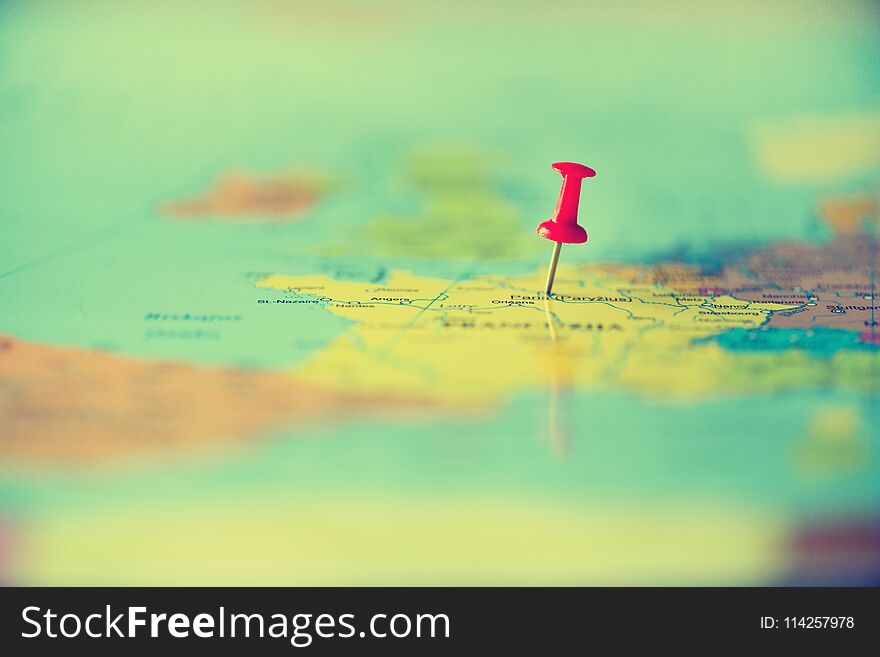 Red pushpin, thumbtack, pin showing the location, travel destination point on map. Copy space, lifestyle concept