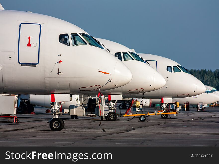 Close-up passenger aircraft noses in line at the parking lot of airport