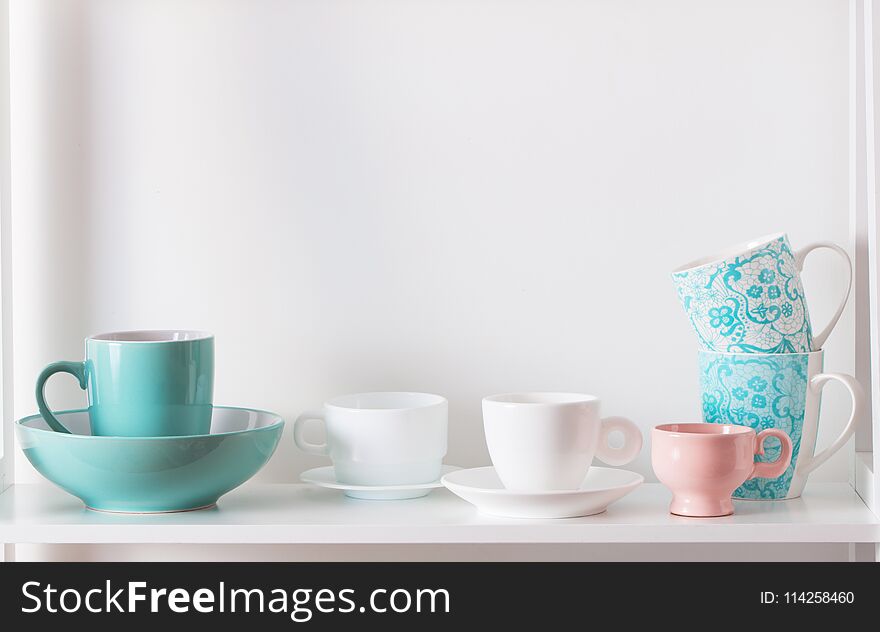 The cups on white shelf on white background