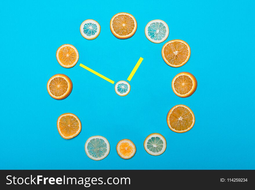 Clock, citrus fruit instead of bars and arrow in the middle. Clock, citrus fruit instead of bars and arrow in the middle