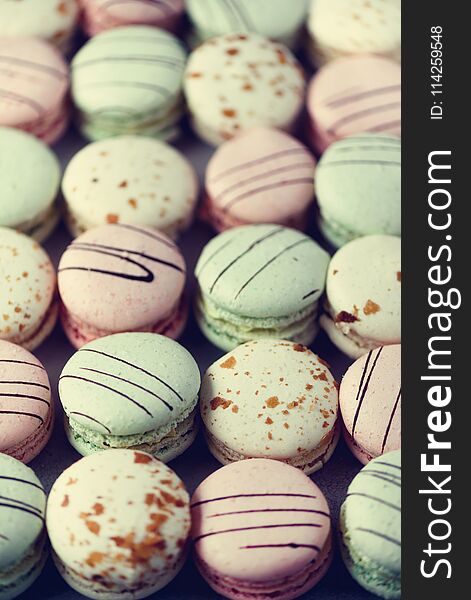 Colorful French Macaroons Flat Lay. Pastel Colors Pink, Green, Yellow Macarons With Copy Space, Top View. Holidays And