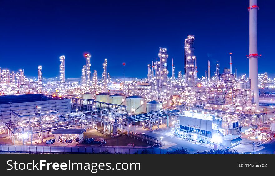 Oil storage tank with oil refinery background, Oil refinery plant at blue night sky.