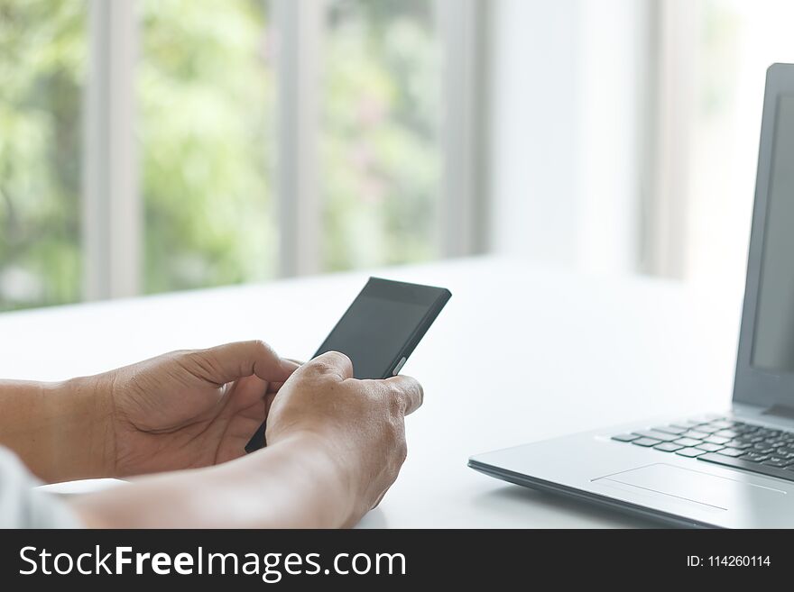 Businessman use smartphone on white table for communication concept