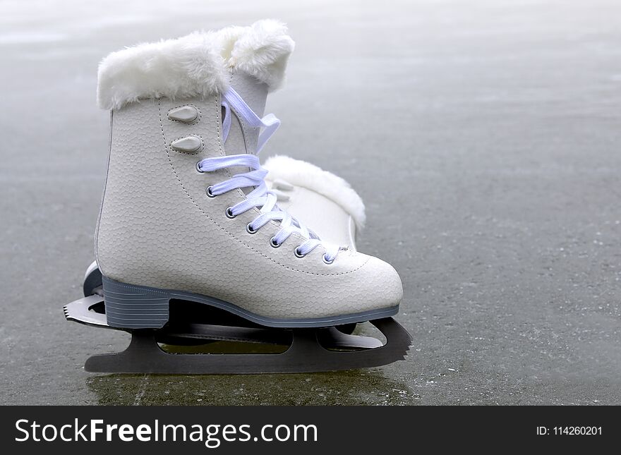 Pair of skates for figure skating on ice rink. Pair of skates for figure skating on ice rink.