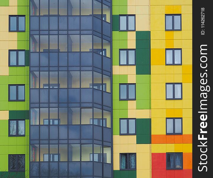 Modern beautiful new buildings. Colored wall on the background of blue sky.