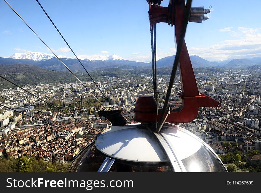 Grenoble eggs aerial tram of Bastille : city overview panorama landscape upon town, buildings, and snowed mountains, in Isere, France. Grenoble eggs aerial tram of Bastille : city overview panorama landscape upon town, buildings, and snowed mountains, in Isere, France