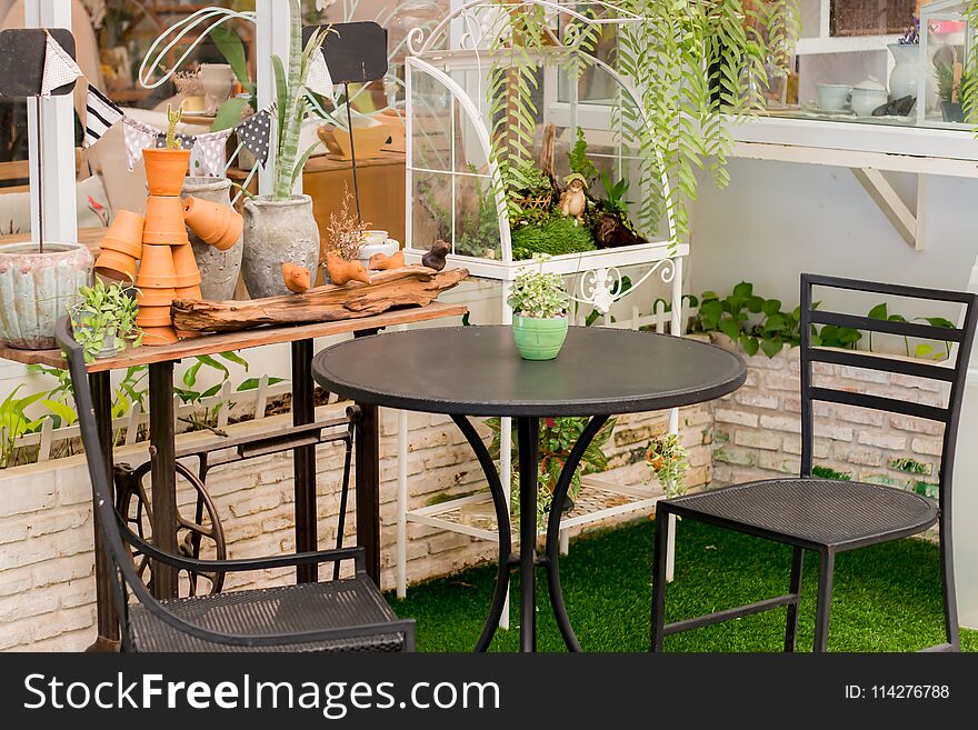 Table iron chair in the backyard grass.