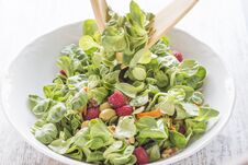 Serving Salad Of Canons, Raspberries, Raisins, Olives, Nuts, Carrots And Pips. Stock Image