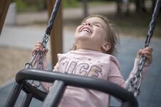 Enjoyment Of A Little Girl From Riding On A Swing Stock Images