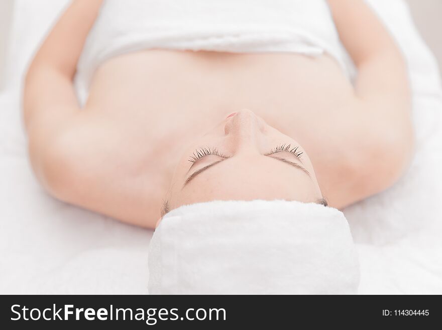 Young woman relaxing at health spa massage