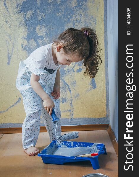 Little kid girl making renovation at her room.