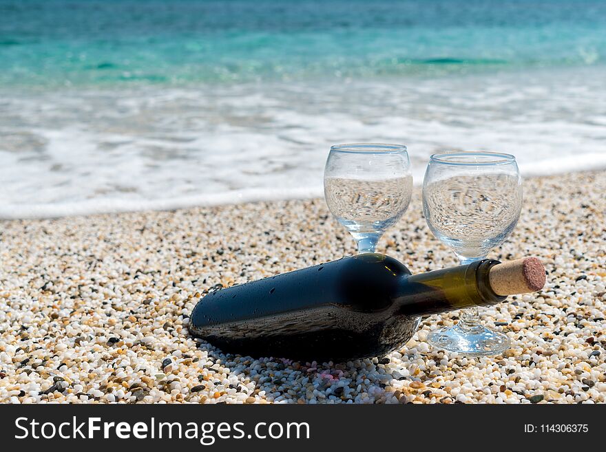 Bottle Of Red Wine With Wine Glasses On The Beach At The Summer Day