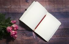 Top View Of Blank Sheet Of Notebook And Red And Pink Roses Flowers On Rustic Brown Wooden Table. Copy Space. Stock Images