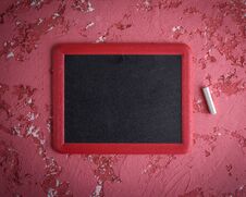 An Empty Black Chalk Board In A Red Frame And A Piece Of Chalk Royalty Free Stock Photo