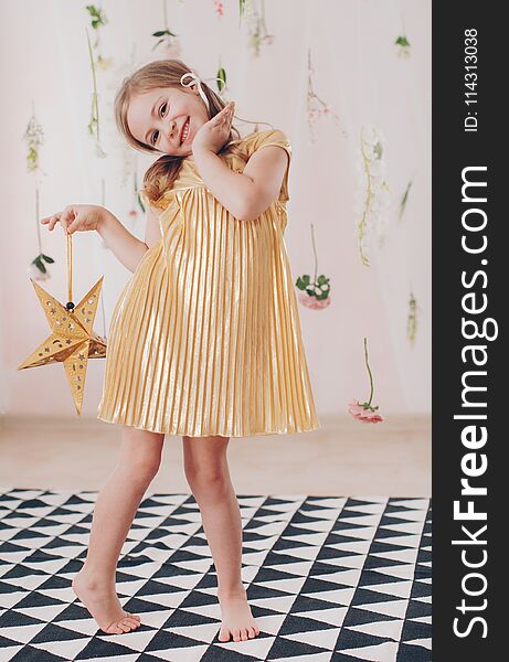 Beautiful happy girl photographed in studio in a beautiful dress