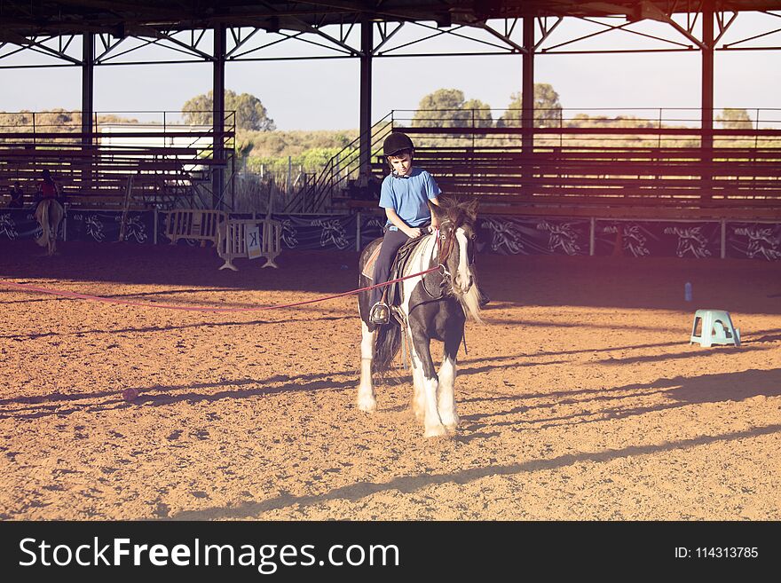 Ber Yakov, Israel - September 28, 2016: Horse riding lessons for kids. The boy on the horse