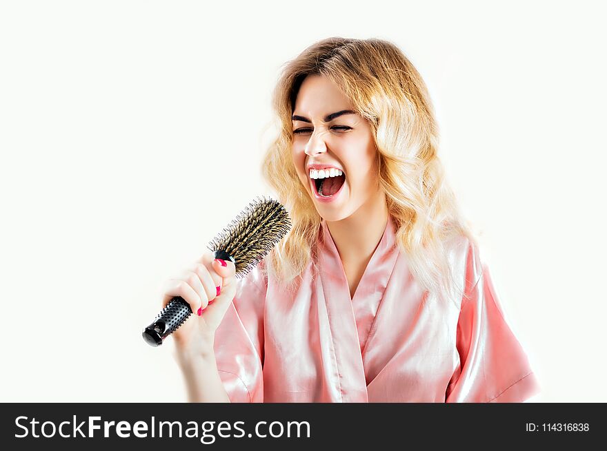 Charming girl in a dressing gown is sung in a comb.