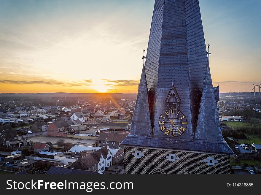 Drone shot close up of a church tower clock at golden hour. Drone shot close up of a church tower clock at golden hour