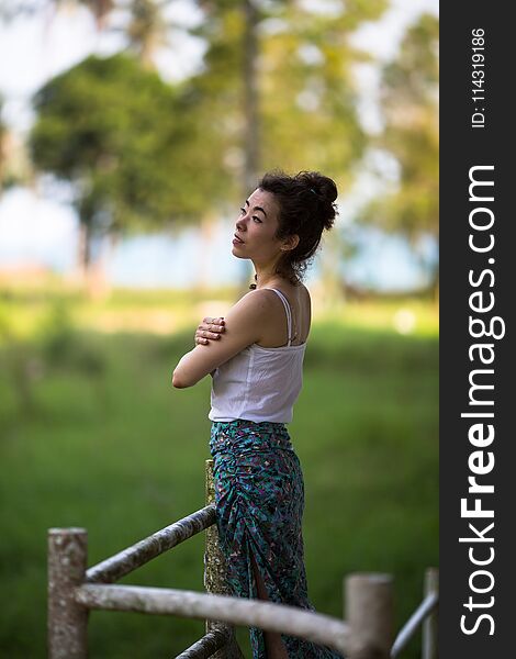 Fashionable girl of mixed race on an abandoned facility in the jungles of Asia. Fashionable girl of mixed race on an abandoned facility in the jungles of Asia.