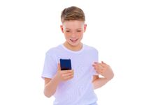 A Little Boy Uses A Mobile Phone. Stock Images A Little Boy Uses A Mobile Phone. Stock Images