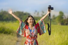 Sweet Young Asian Chinese Or Korean Woman On Her 20s Posing Happy And Playful Holding Photo Camera Smiling Happy In Beautiful Natu Stock Photo