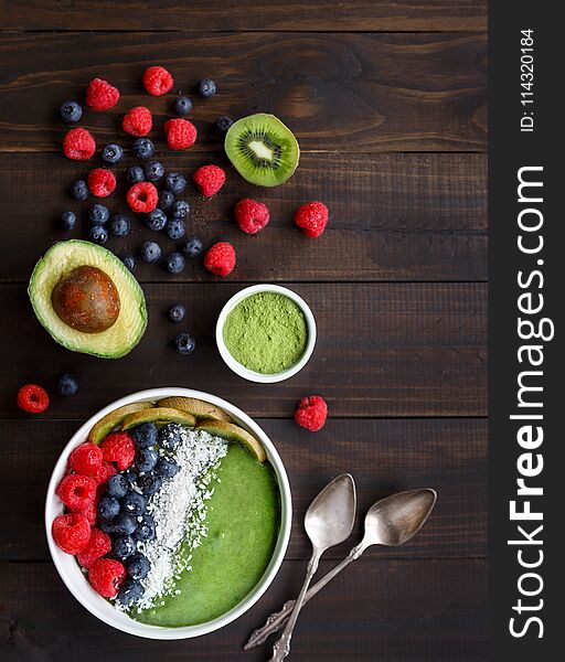 Healthy Green Smoothie Bowl on a Rustic Wooden Surface Shot from Overhead. Healthy Green Smoothie Bowl on a Rustic Wooden Surface Shot from Overhead