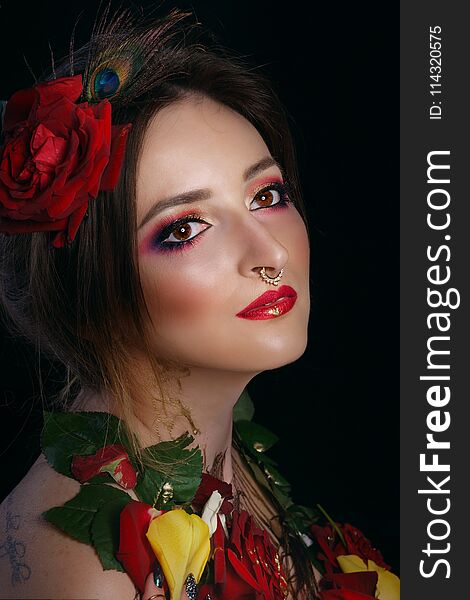 Portrait of a young attractive girl with roses. Passion and sensuality. Creative makeup. Portrait of a young attractive girl with roses. Passion and sensuality. Creative makeup.